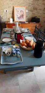 a table with a plate of food on top of it at Chambres D'hôtes Le Fer À Cheval in Montreuil-sur-Maine +10 photos
