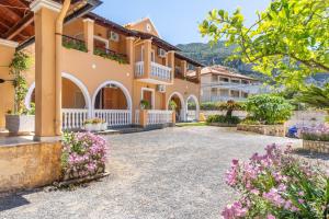 a large house with flowers in front of it at Mires House Front Studio 1 in Agios Gordios