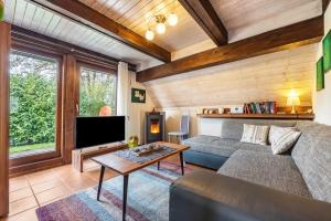 a living room with a couch and a tv at Ferienhaus Elbidylle in Bachenbrock