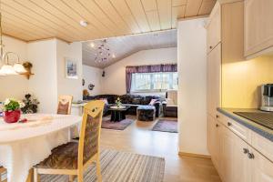 a kitchen and living room with a table and a living room at Ferienwohnung Plötz in Bad Koetzting +17 photos