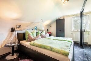a bedroom with a large bed with pillows at Ferienwohnung Plötz in Bad Koetzting