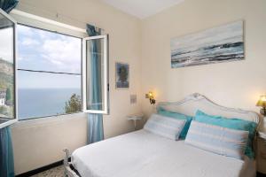 a bedroom with a bed and a large window at Oasi in Alassio
