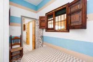 a bedroom with a bed and a wooden cabinet at Casa Basallote in El Palmar