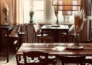 a dining room with a wooden table and chairs at Heart Ferienwohnungen Frida I Kahlo in Vogtsburg +53 photos