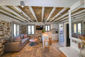 a living room with a couch and a table at Celini Villas Tinos in Tinos