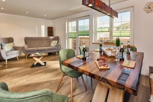 a living room with a wooden table and chairs at Ferienhaus Wendelhof in Eisenbach