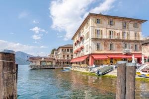 a group of buildings next to a body of water at Antro Di Circe - Orta Centro in Orta San Giulio