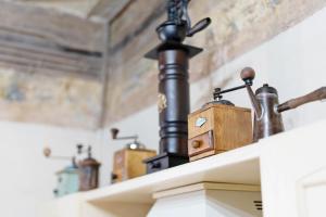a room with pipes and wooden items on a shelf at Antro Di Circe - Orta Centro in Orta San Giulio +34 photos