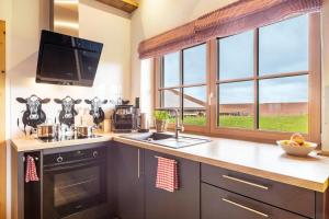 a kitchen with a counter with a sink and a tv at Chalet Bergliebe in Brilon