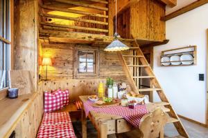 a dining room with a table and a ladder at Chalet Bergliebe in Brilon