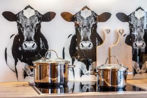 two pots and pans on a counter in front of cows at Chalet Bergliebe in Brilon +21 photos