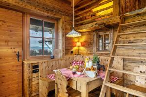 a dining room with a table in a wooden cabin at Chalet Bergliebe in Brilon