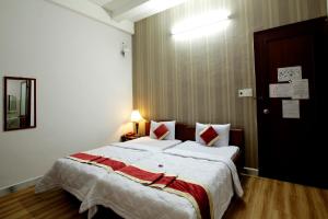 Postel nebo postele na pokoji v ubytování Tan Da Hotel