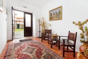 a room with a table and chairs and a door at Casa do Adro do Soajo in Soajo