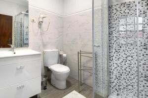 a bathroom with a toilet and a glass shower at Casa do Adro do Soajo in Soajo +34 photos