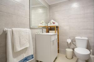 a bathroom with a toilet and a sink and a mirror at Los Abuelos 2 Icod in Icod de los Vinos +21 photos