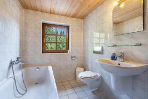 a bathroom with a sink and a toilet and a tub at Ferienhaus Henneberg in Johanngeorgenstadt +25 photos