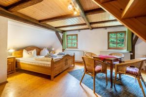 a bedroom with a bed and a table and chairs at Ferienhaus Henneberg in Johanngeorgenstadt