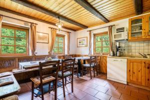 a kitchen with wooden cabinets and a table and chairs at Ferienhaus Henneberg in Johanngeorgenstadt