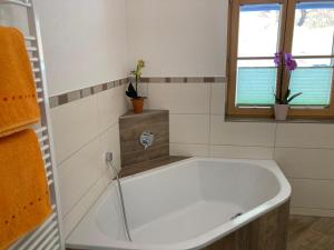 a white bath tub in a bathroom with a window at Urlaub bei Schönwetter in Raumberg