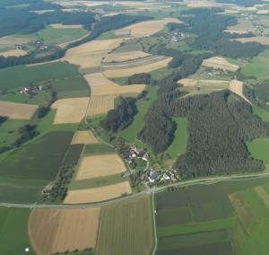 an aerial view of a field with trees and houses at Ferienwohnung Braun in Seelfingen +2 photos
