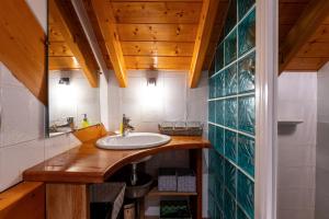 a bathroom with a sink and a mirror at Locdecharme in Les Clefs +27 photos