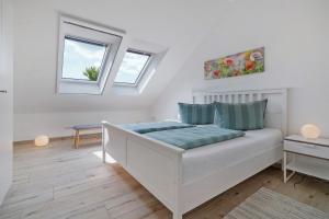 a bedroom with a bed and two windows at Ferienwohnung Auszeit in Kargow