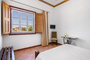 a bedroom with a bed and a window at Casas do Monte in Giões +135 photos