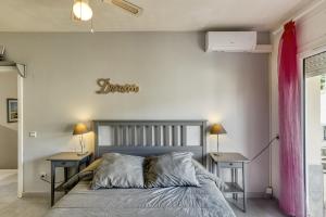 a bedroom with a bed and two night stands at Casa 3 Dormitorios Con Piscina in L'Escala +27 photos