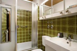 a bathroom with a sink and a shower and a toilet at Appartment Gute Zeit in Weiler-Simmerberg +18 photos