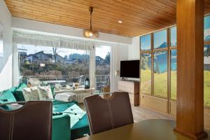 a living room with a couch and a table and a television at Appartment Gute Zeit in Weiler-Simmerberg