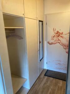 a closet with a picture of a cow on the wall at Appartment Gute Zeit in Weiler-Simmerberg