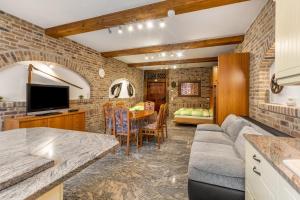 a kitchen and living room with a couch and a tv at Ferienwohnungen Bunge in Krostitz