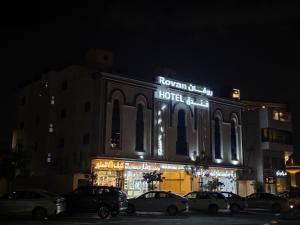 a building with cars parked in front of it at night at فندق روفان in Medina