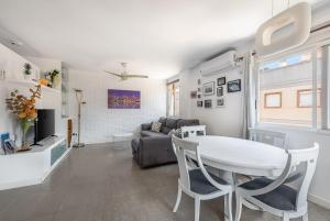 a living room with a table and a couch at Amplio Canet in Canet de Berenguer
