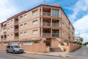 a building with a car parked in front of it at Amplio Canet in Canet de Berenguer