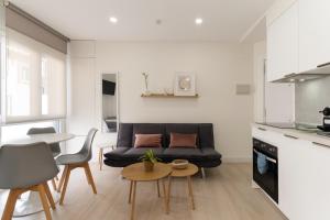 a living room with a couch and a table at Cala Sol - few steps from the beach in La Cala de Mijas