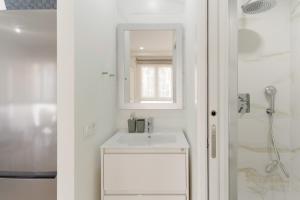 a white bathroom with a sink and a shower at Cala Sol - few steps from the beach in La Cala de Mijas +25 photos