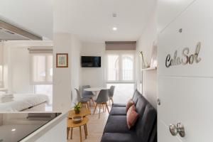 a living room with a couch and a table at Cala Sol - few steps from the beach in La Cala de Mijas