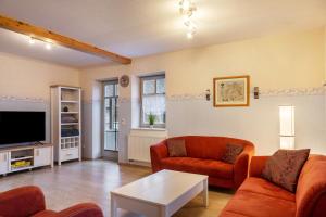 a living room with two couches and a tv at Ferienwohnung 1 Hof Schäfer in Waldeck