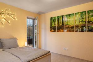 a bedroom with two paintings on the wall at Ferienwohnung 1 Hof Schäfer in Waldeck