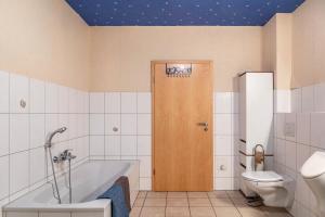 a bathroom with a bath tub and a toilet at Ferienwohnung 1 Hof Schäfer in Waldeck +17 photos