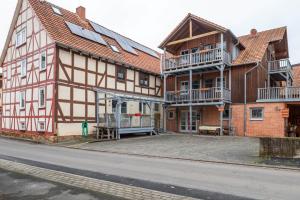 a large wooden building with a balcony on a street at Ferienwohnung 1 Hof Schäfer in Waldeck