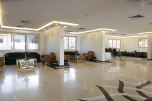 a large room with a lobby with couches and tables at فندق روفان in Medina