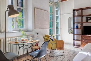 a living room with a table and chairs at Studio Apartment 1 Min From Lake in Como