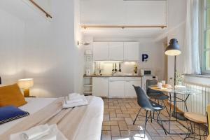 a kitchen and a living room with a table and chairs at Studio Apartment 1 Min From Lake in Como