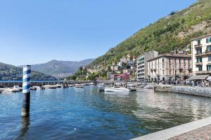 a river in a city with boats in the water at Studio Apartment 1 Min From Lake in Como