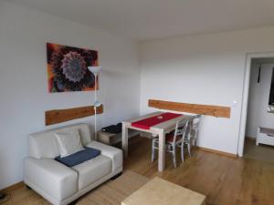 a living room with a couch and a table at Clausberg Ferienwohnungen in Gerstungen