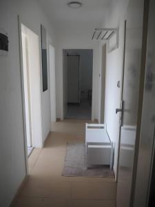 an empty hallway with a bench in a room at Clausberg Ferienwohnungen in Gerstungen +5 photos