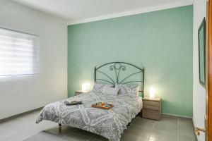 a bedroom with a bed with two candles on it at 2a Francesca in Vecindario